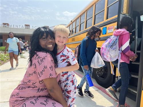 Student getting hug from his kindergarten teacher, Ms. Davis